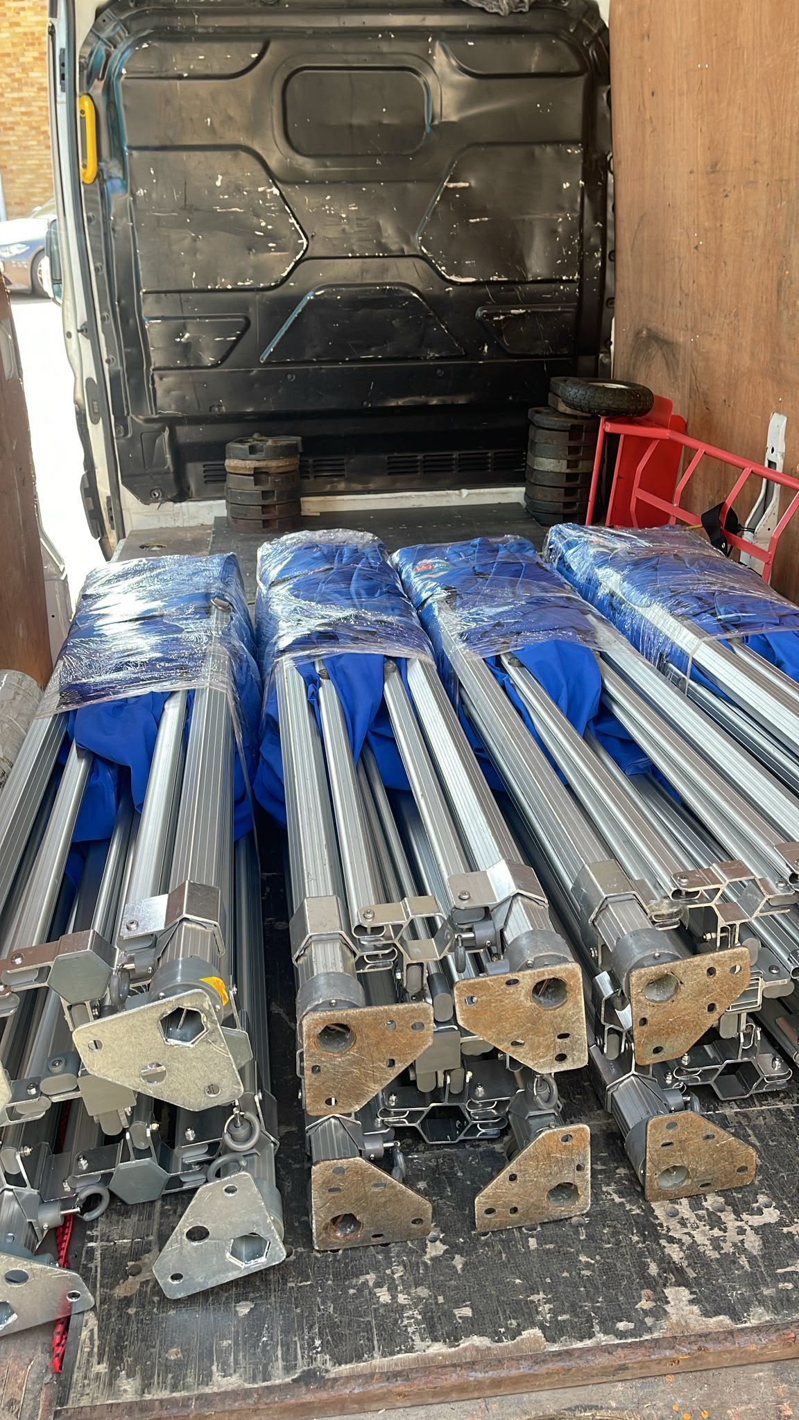 Long blue metal equipment loaded inside a van