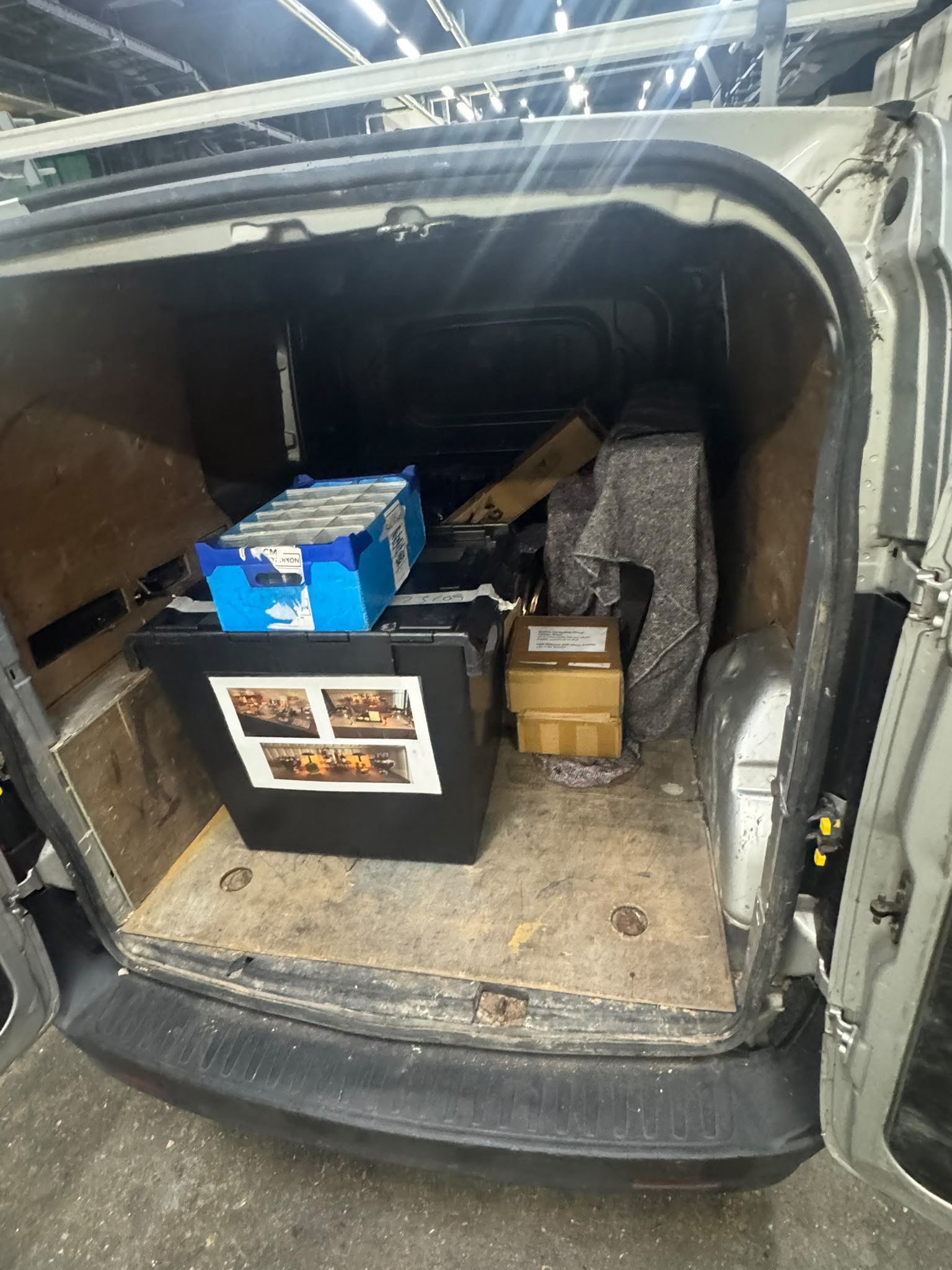 Boxes and framed items inside the rear of a delivery van