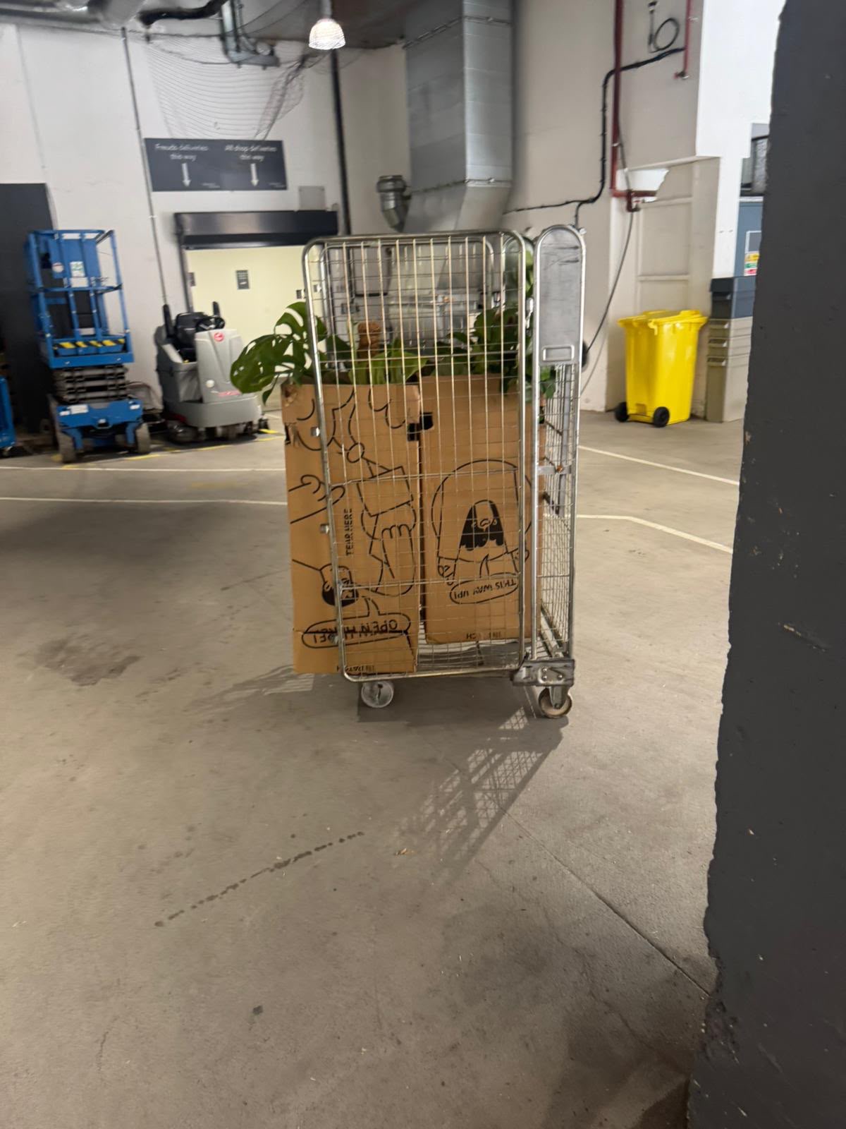 Boxed items on a wheeled cage in a warehouse
